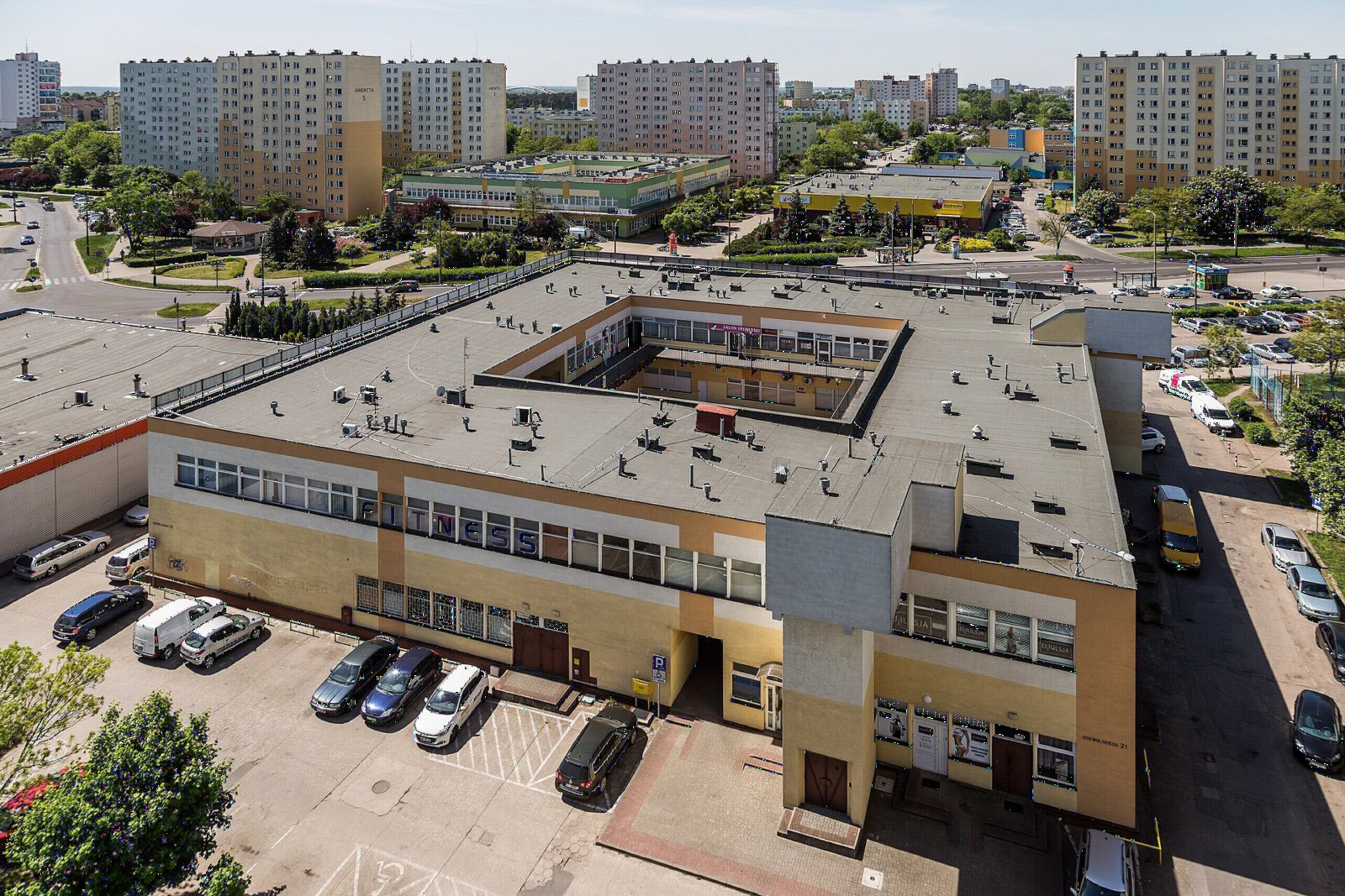 Widok z góry na centrum osiedla Rubinkowo w Toruniu z blokami i pawilonami